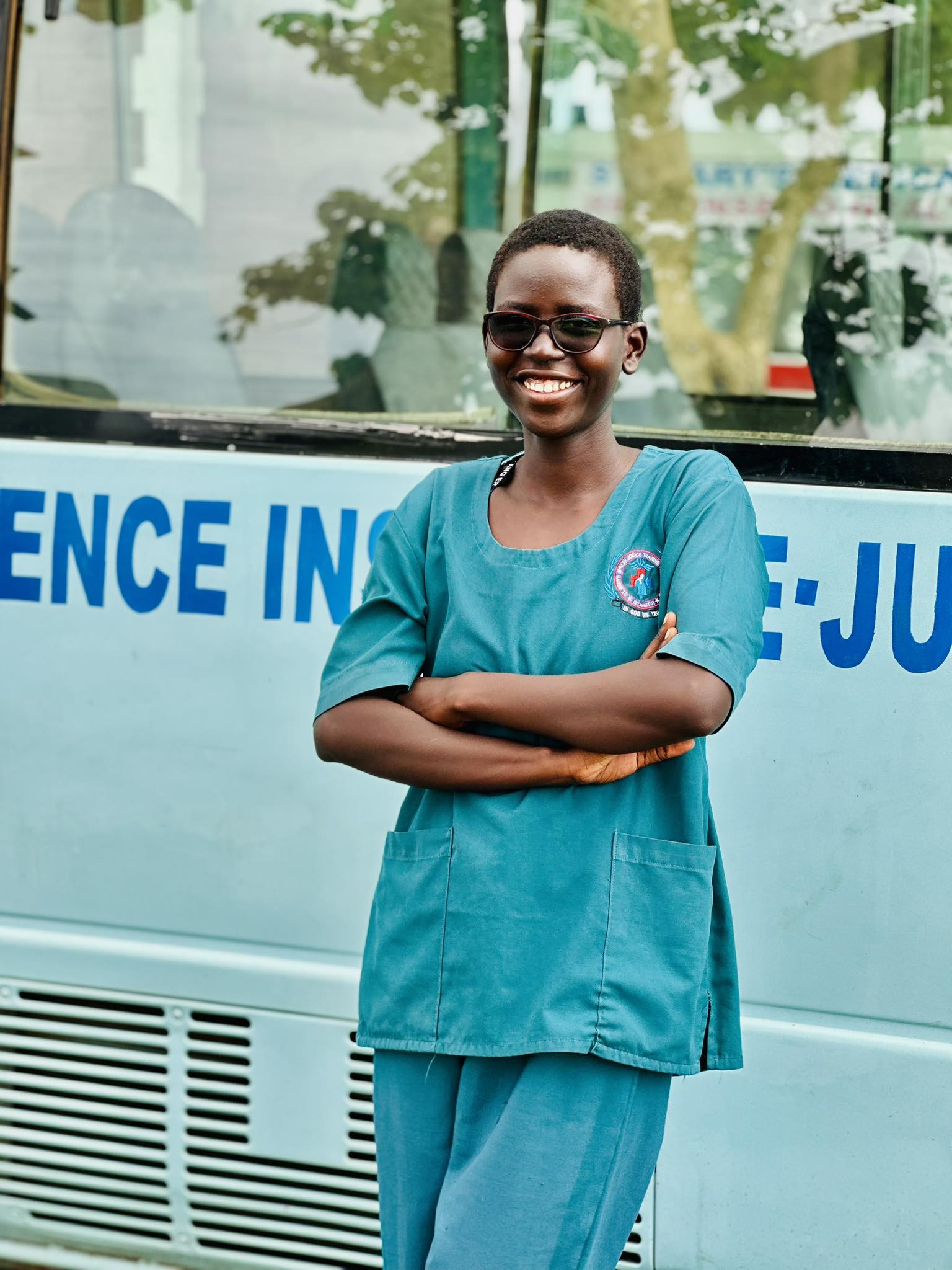 Two graduates smiling with flowers