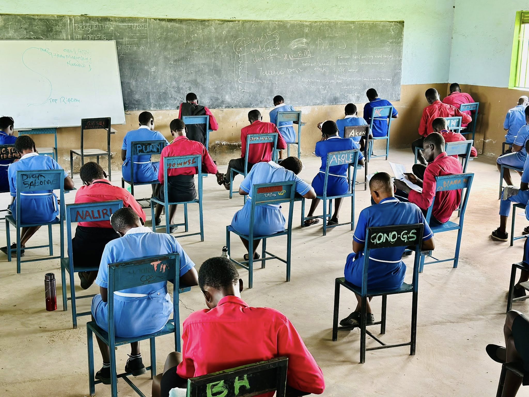 Graduates in caps and gowns with ST.MHSTIJ sashes