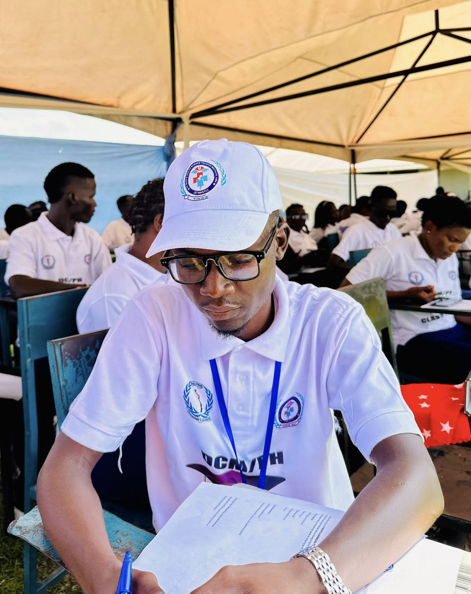 Student examining patient on ward bed