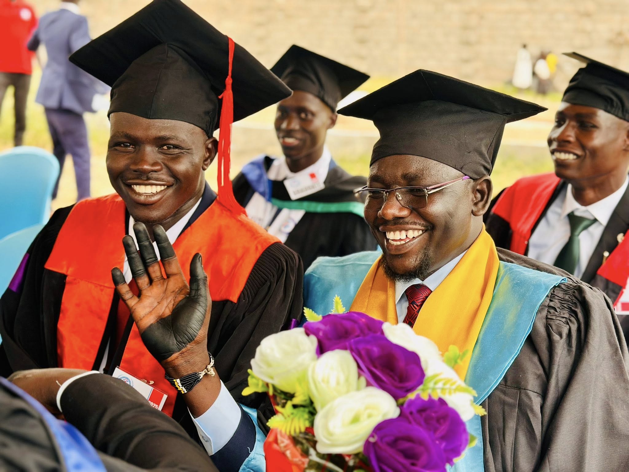 Student in teal scrubs by school bus