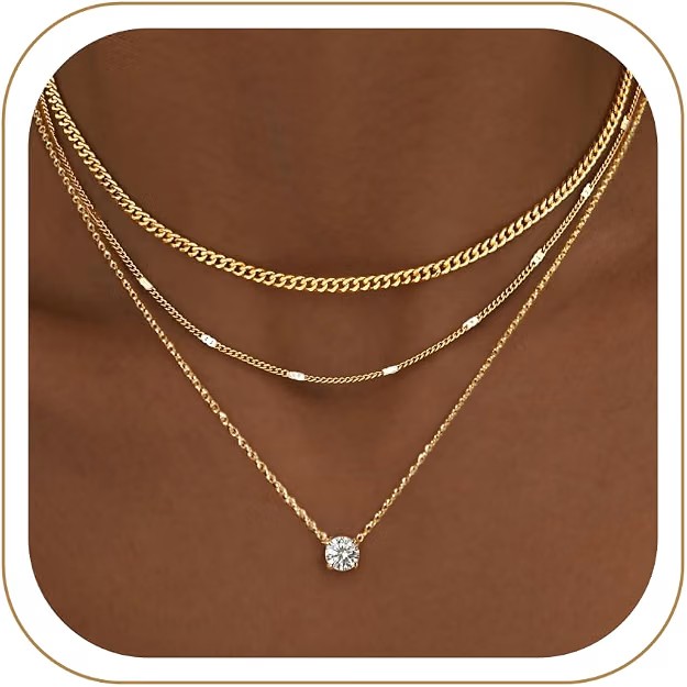 Necklace Stack (Gold) — Layered chains, the one warm-metal moment in a cool-toned edit.