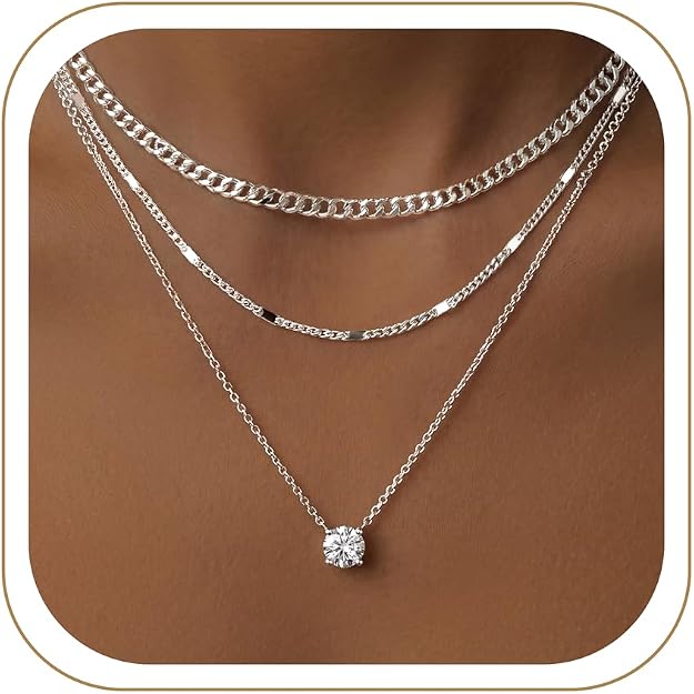 Necklace Stack (Silver) — Three silver chains, one small pendant.