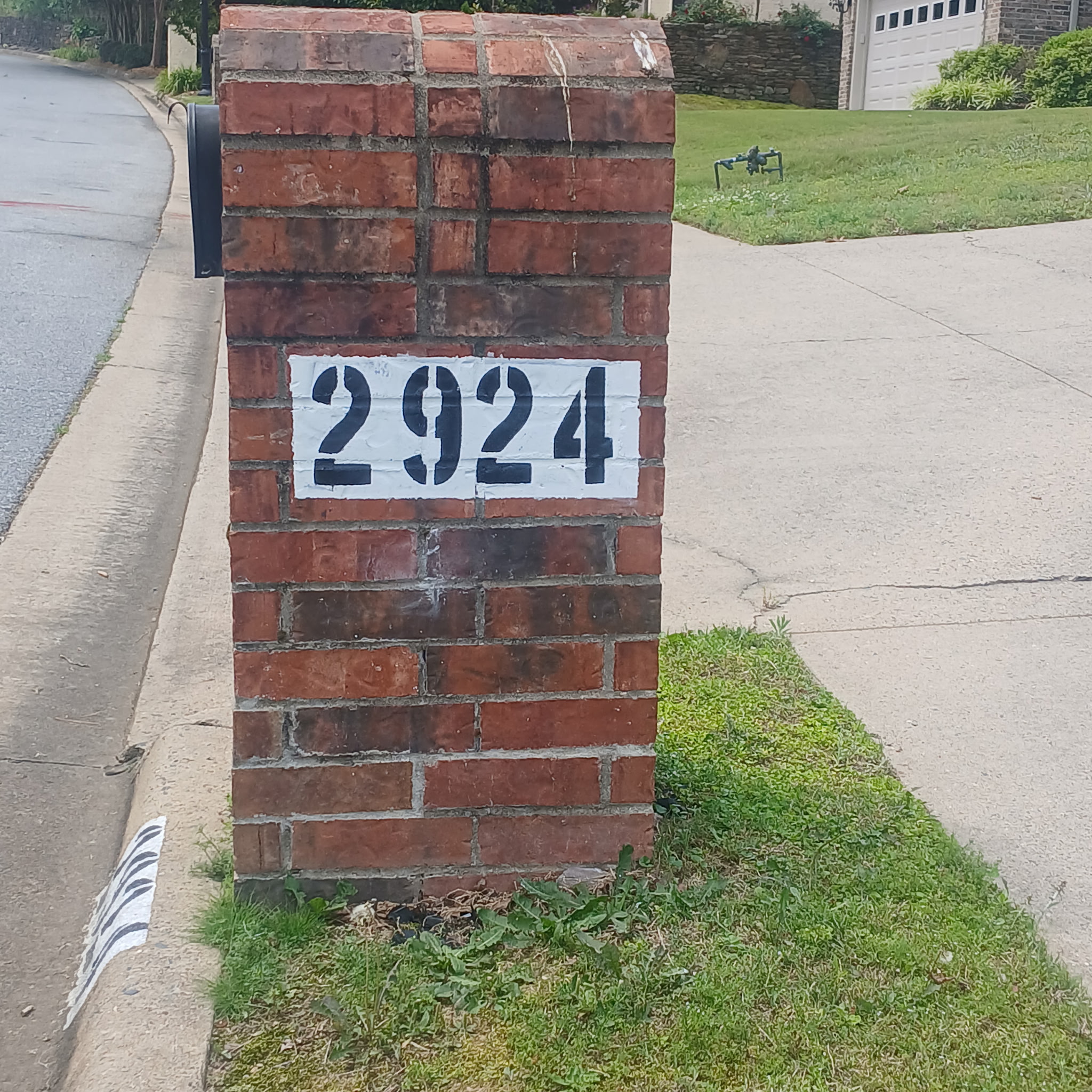 Mailbox post painting — address 2924 in bold black numbers on white background on brick mailbox pillar