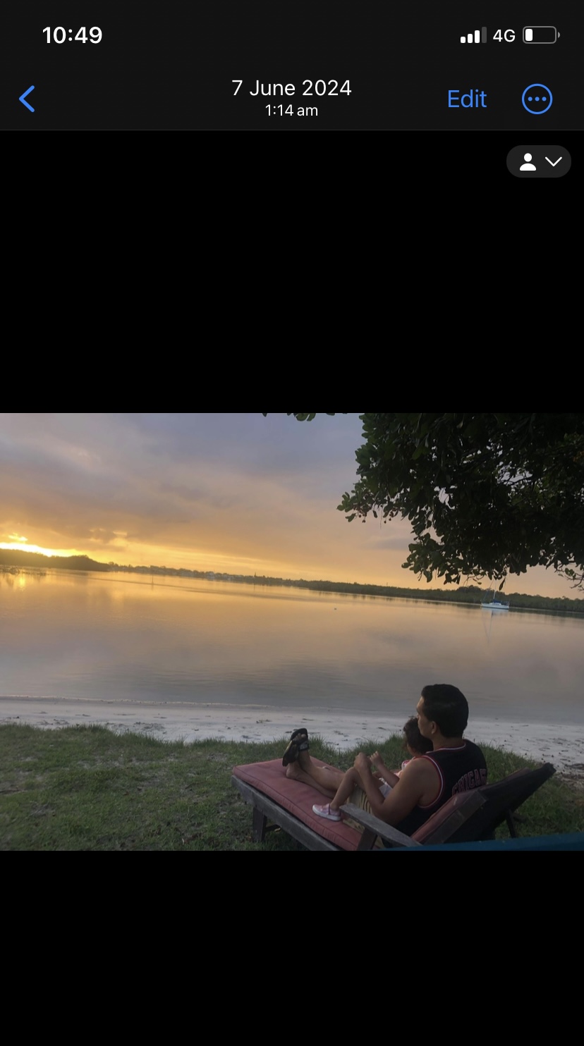 Konstantin and his daughter watching the sunset by the water — peace after the storm