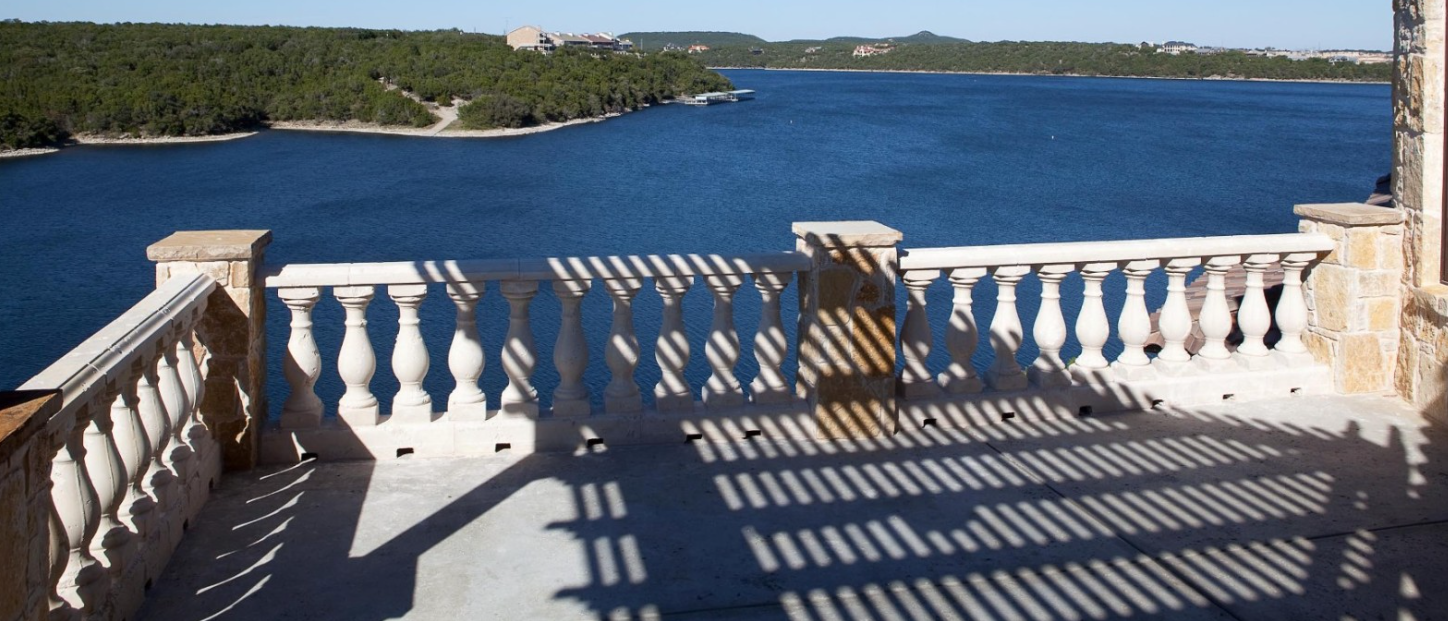 Lakeside cast stone balustrade with classical turned balusters on waterfront terrace