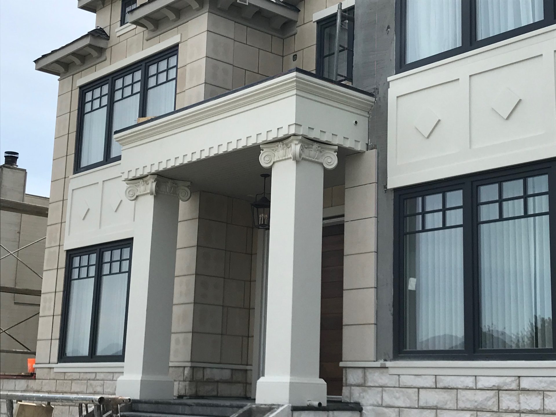 Ionic columns entryway with dentil molding