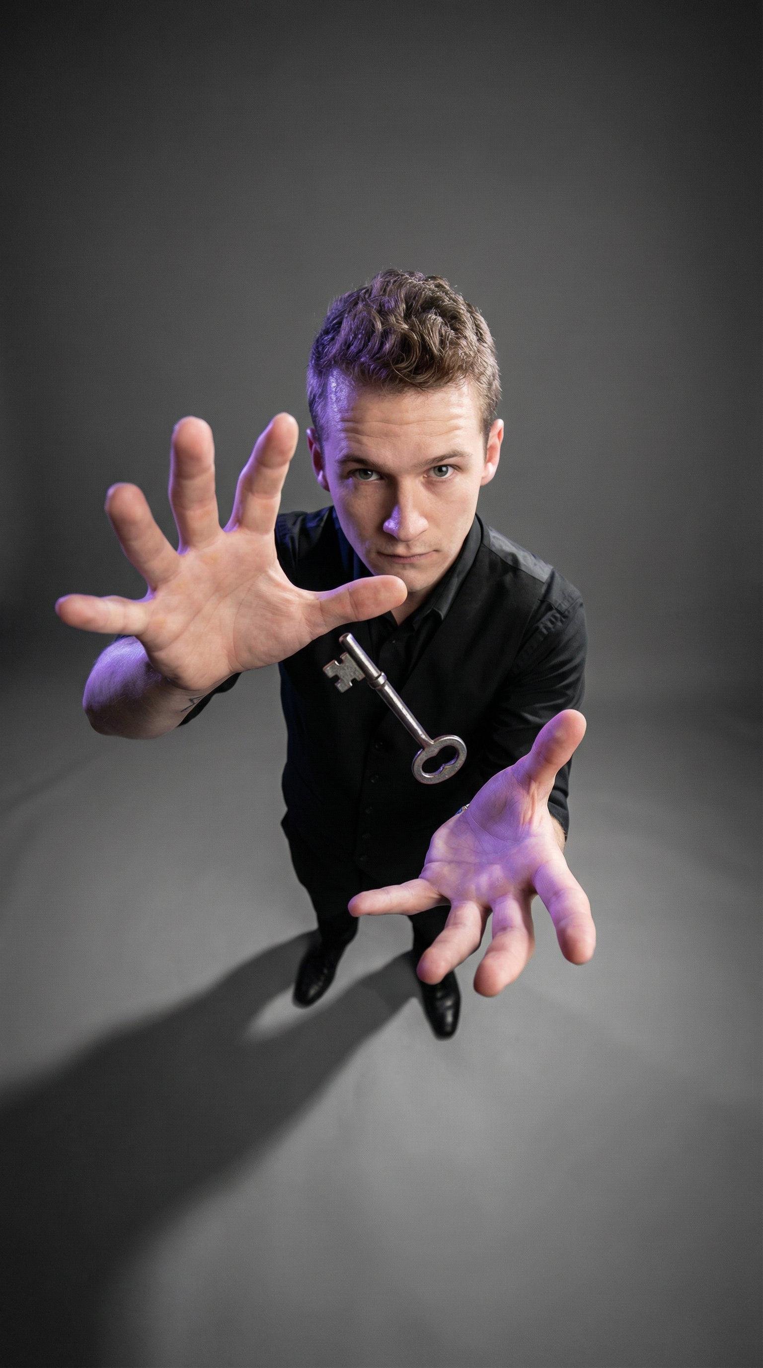 Foggy Jack posing with both hands extended and a key at his chest