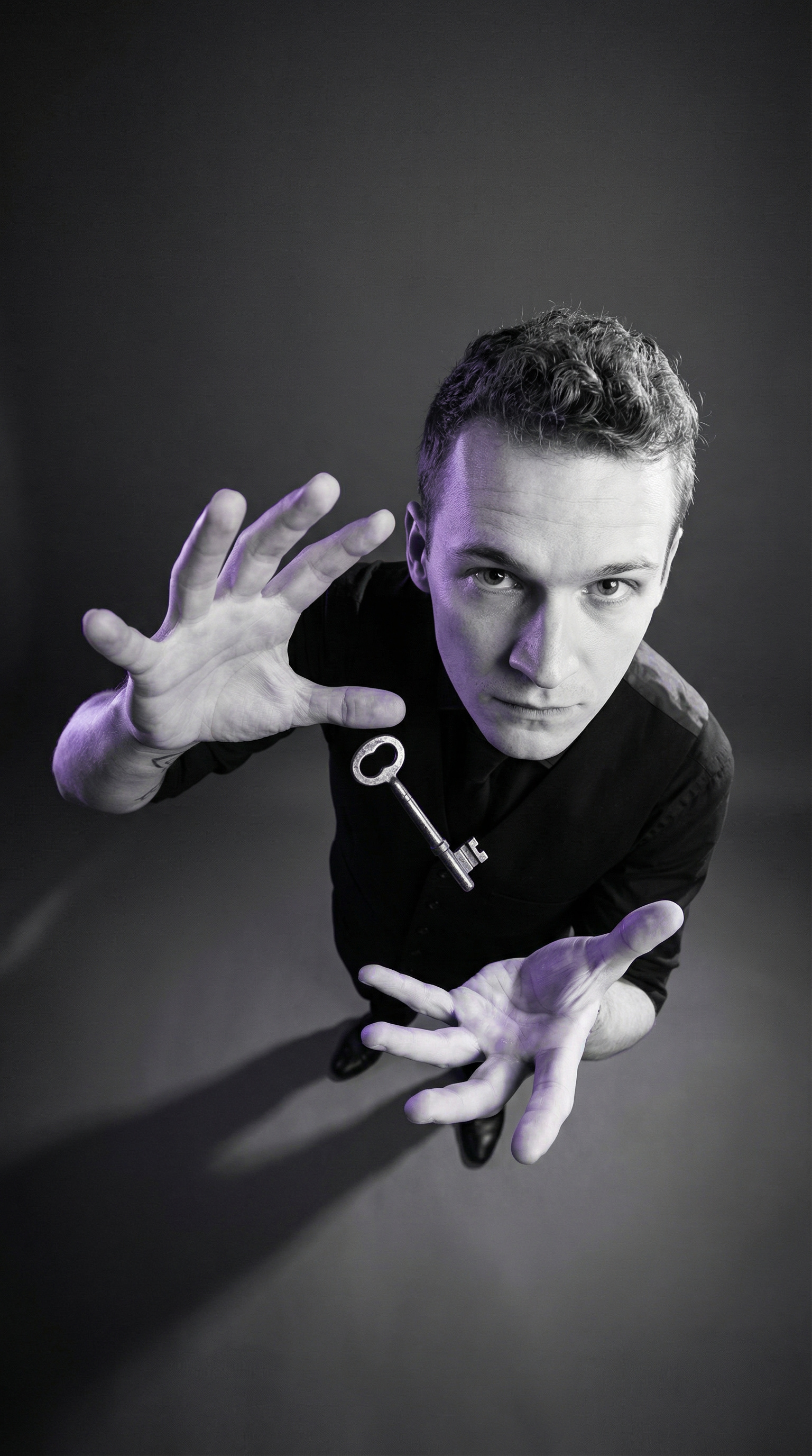 Foggy Jack reaching toward the camera with a key during a portrait session