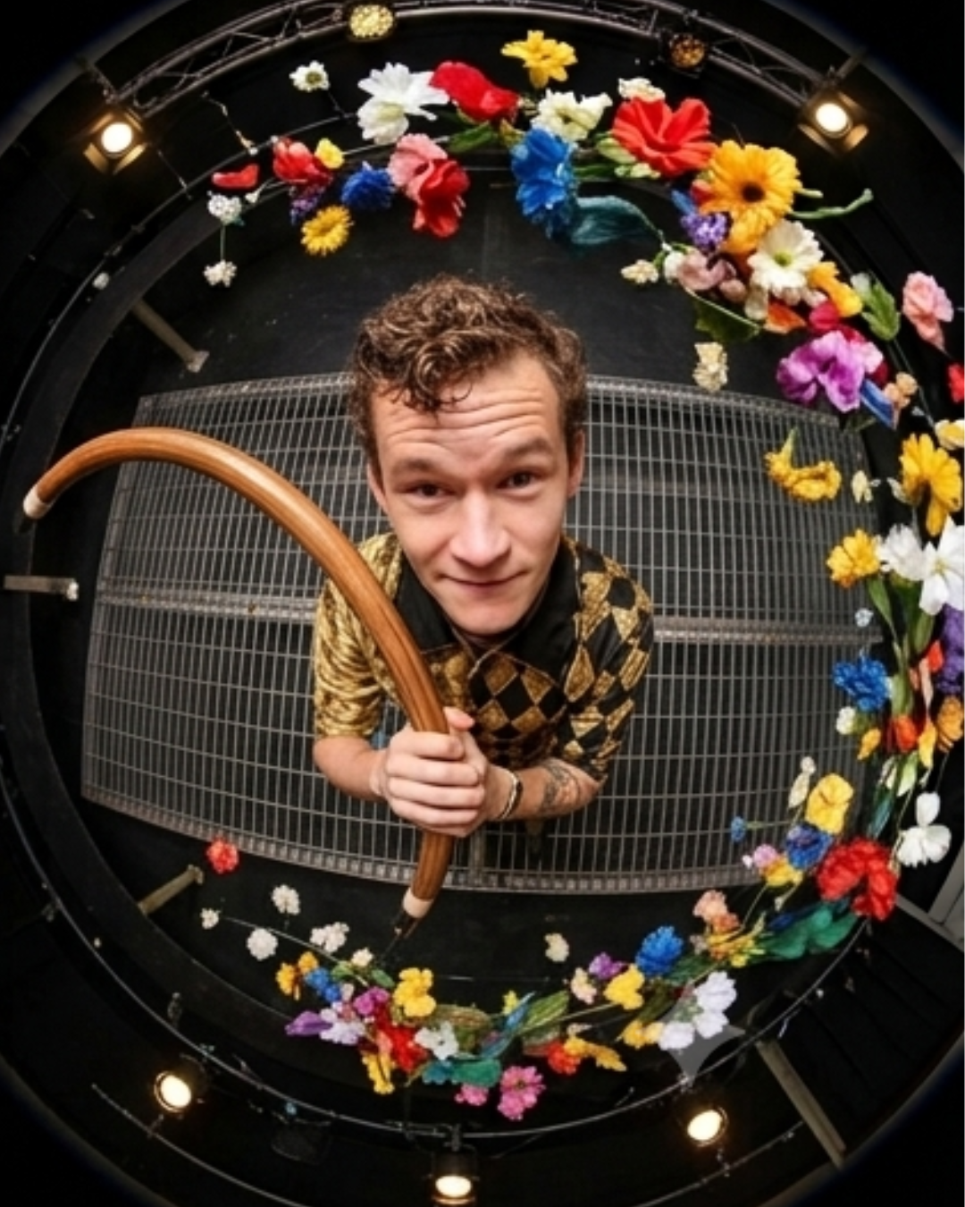 Foggy Jack performing inside a flower-framed stage set