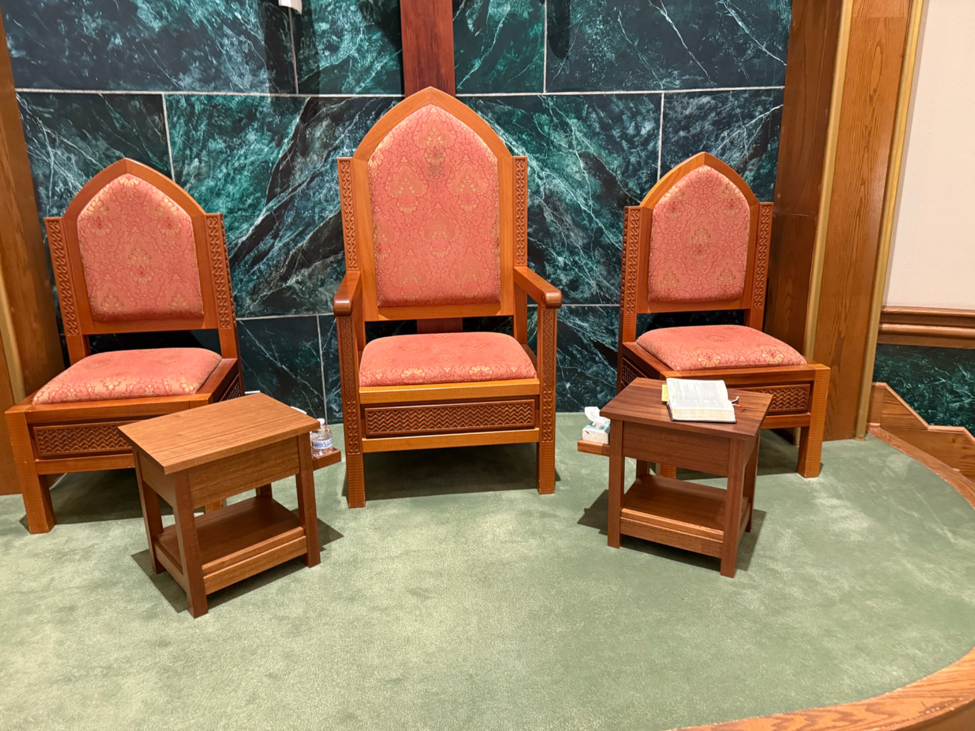 Three presider and deacon chairs with handmade side tables in church sanctuary