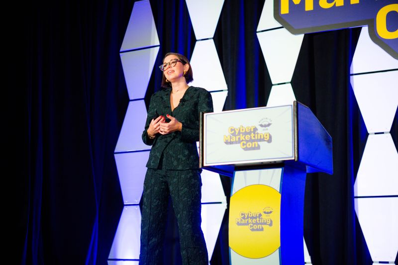 Jacqui speaking on stage at a cybersecurity marketing conference keynote