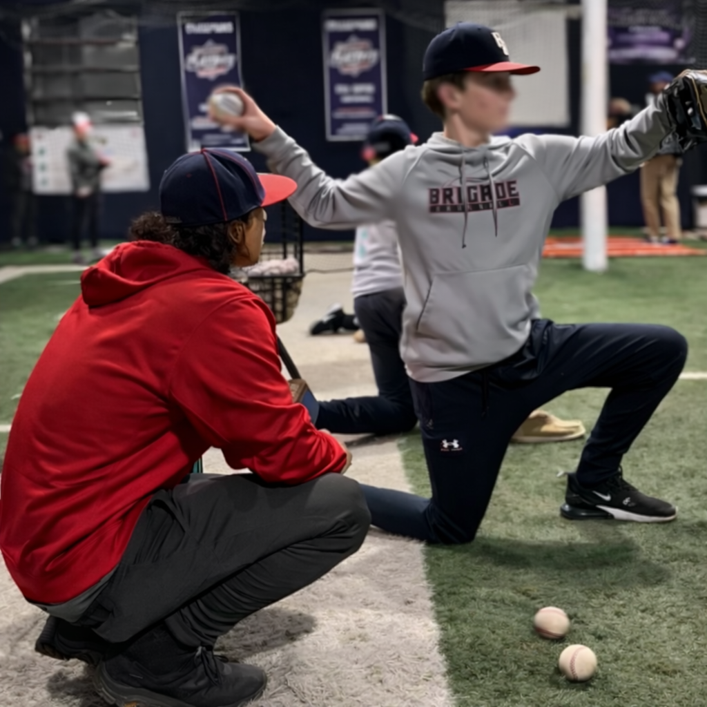Coach Silvio watching athlete's throwing form