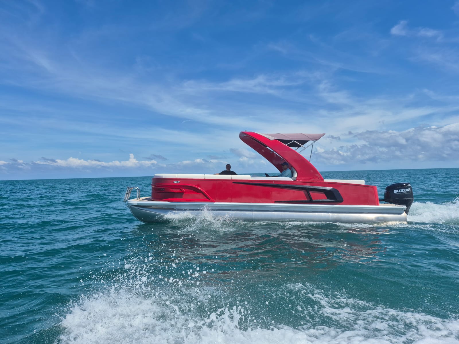 The owner's red boat on the sea for Lumen Retreat tours.