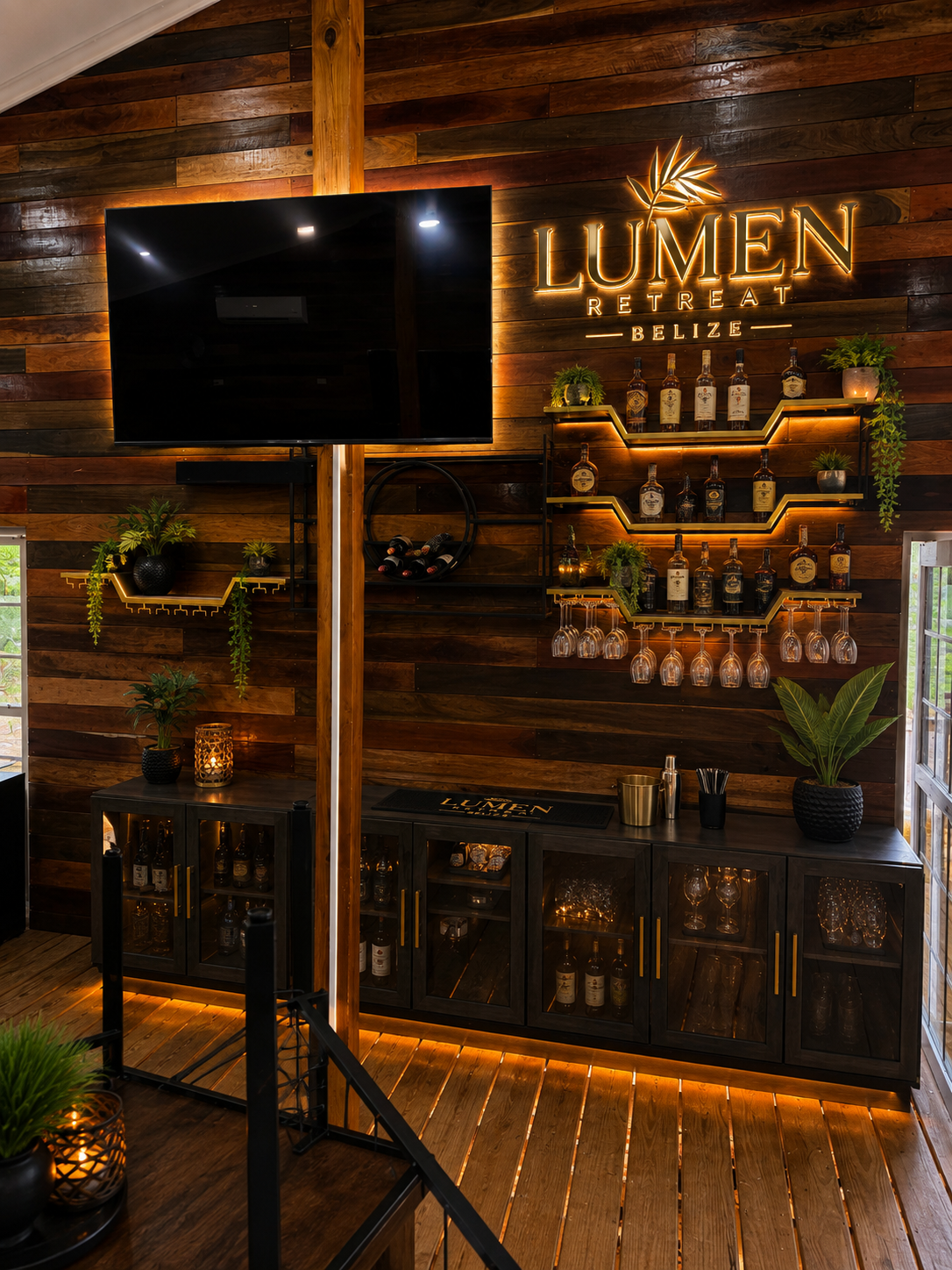 Indoor bar with Lumen signage and illuminated shelving.