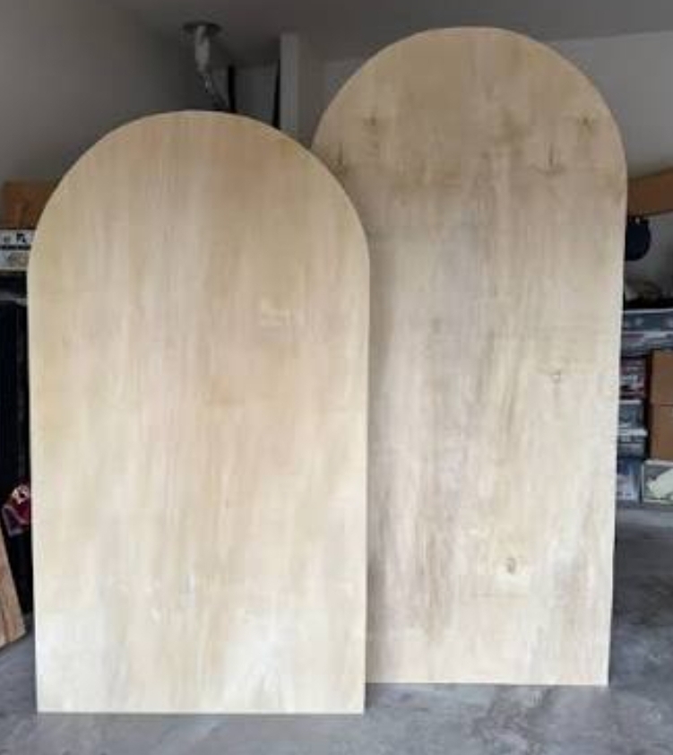 Wooden arch backdrop decorated with florals by Hippie Shenanigans