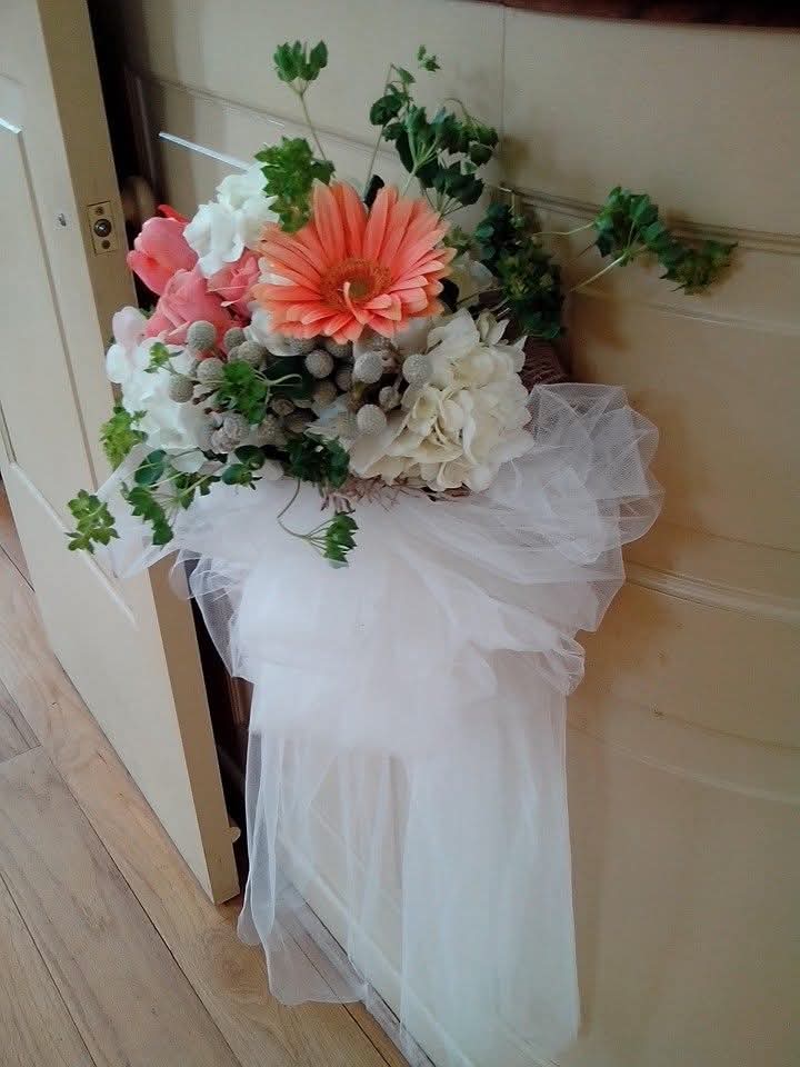 Tulle and floral pew arrangement