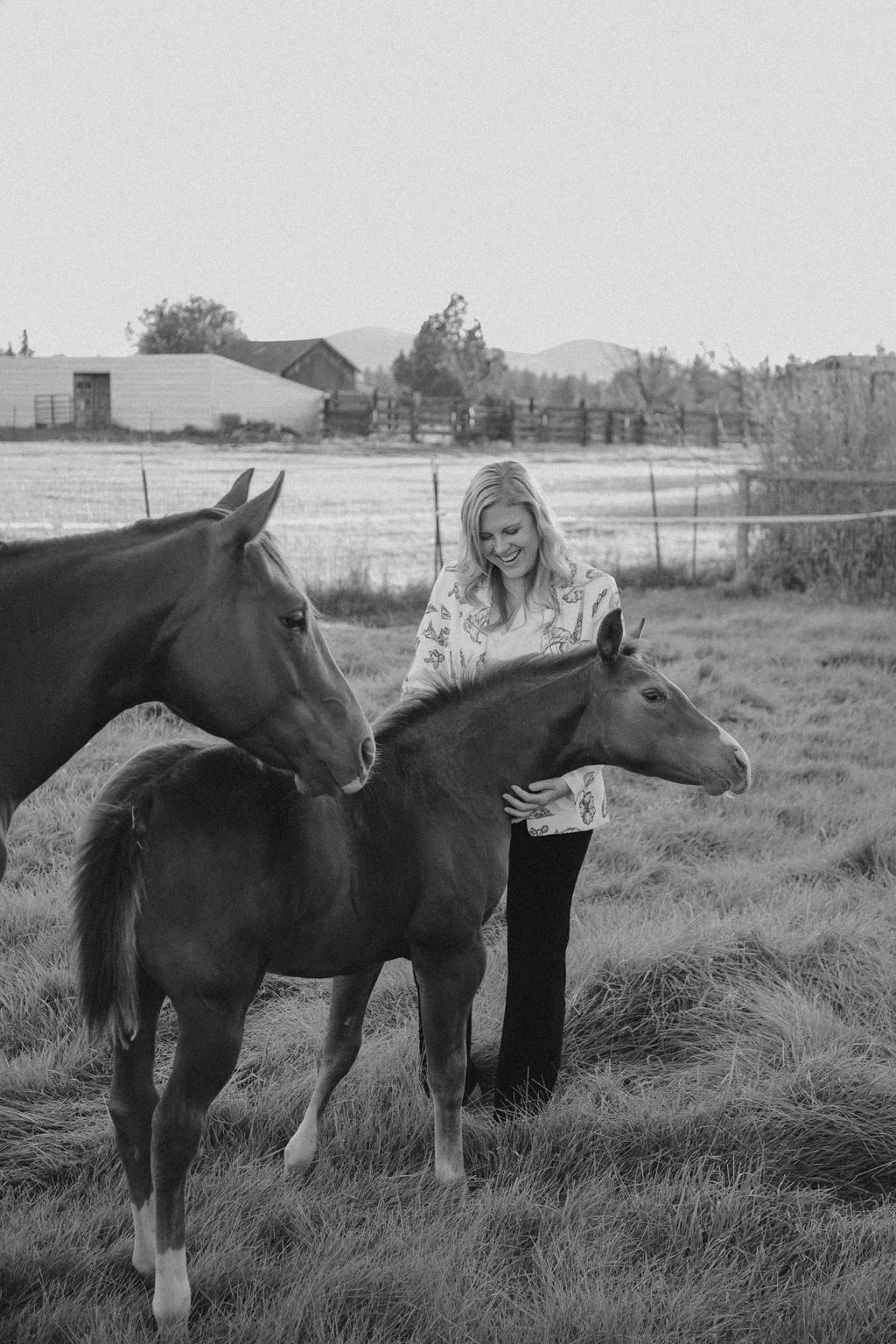 Christina with horses and foal in black and white