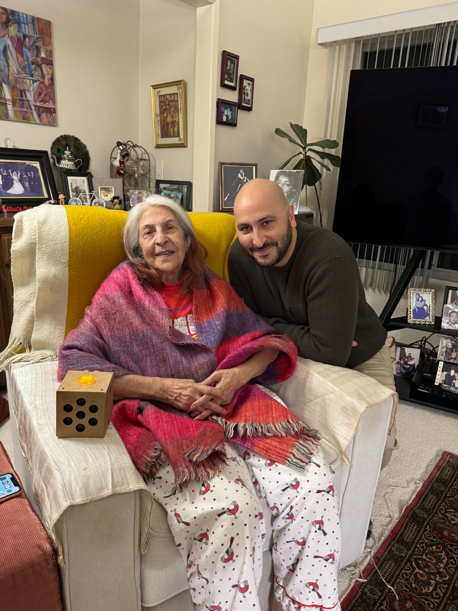 Founder with his grandmother using the original Grannybot prototype