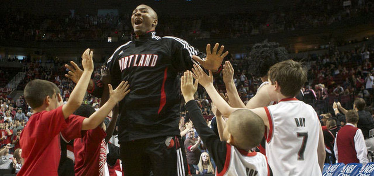 Armon Johnson high-fiving fans in Portland