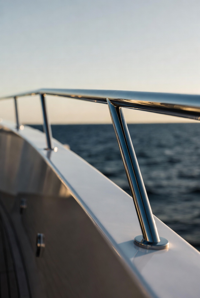 Close-up polished stainless steel railing stanchions on superyacht deck