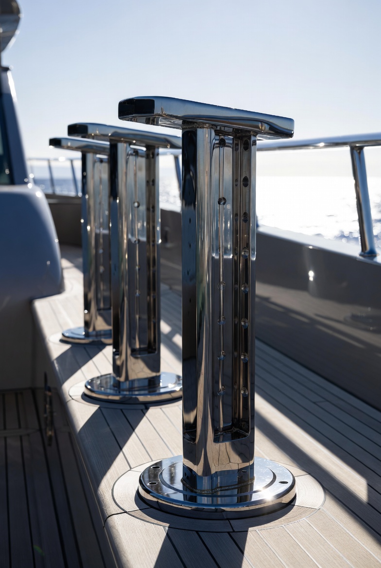 Polished stainless steel deck stanchions and bollards on teak deck superyacht