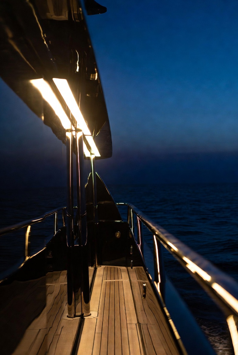 Night shot of illuminated superyacht deck railings and walkway lighting