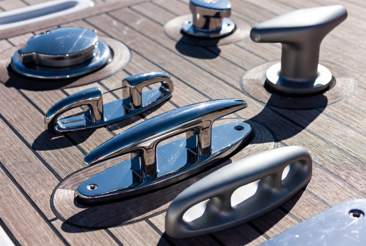 Deck hardware layout with cleats, bollard, and fairleads on teak superyacht deck