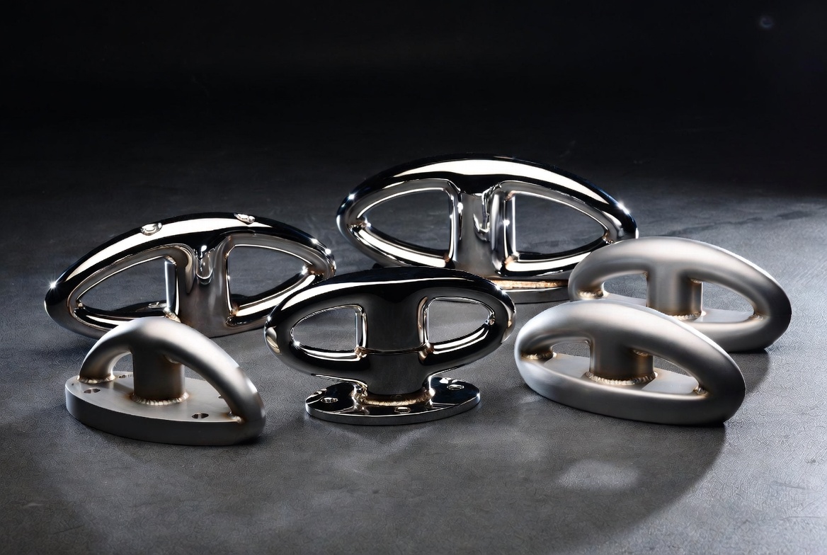 Collection of polished and brushed stainless steel marine cleats and chocks