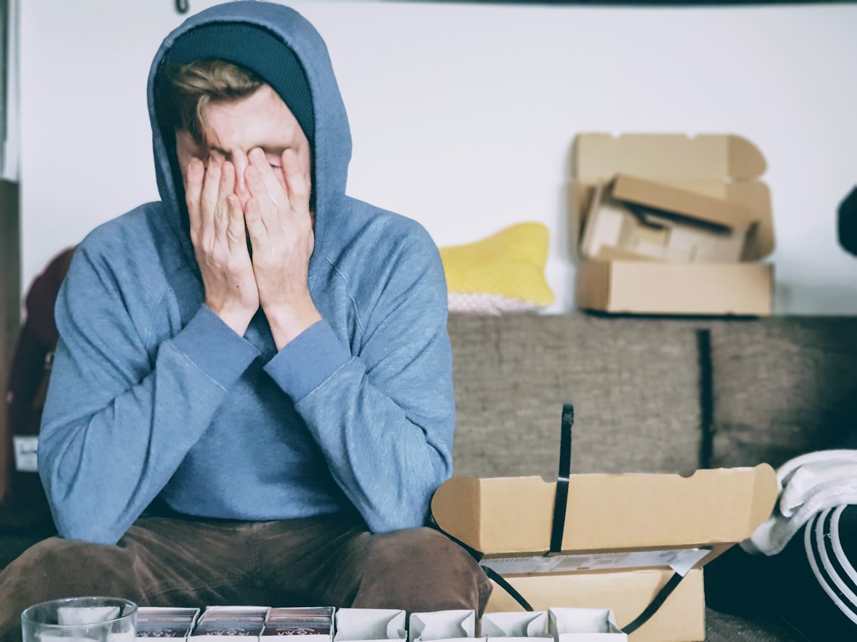 Person with head buried in hands showing the distress of organizational transformation failure