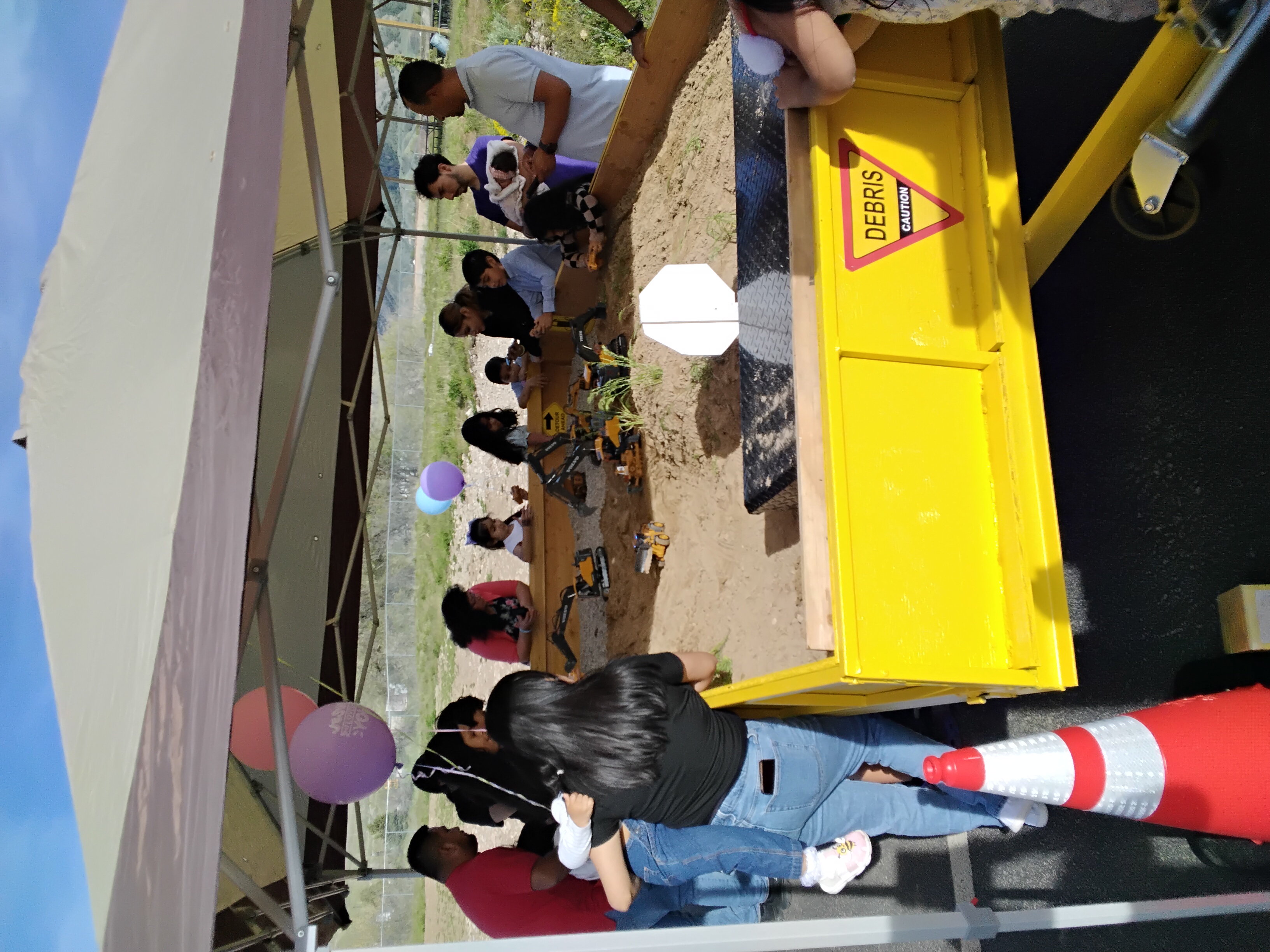 Families and kids crowded around The Sand Castle Station at a Cache Valley church event
