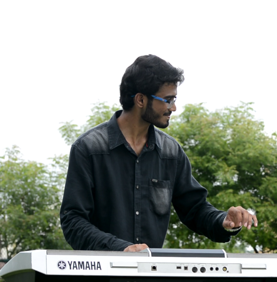 Yashodeep playing keyboard outdoors in natural light