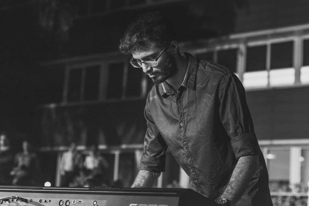 Yashodeep Sant performing on stage — dramatic black and white