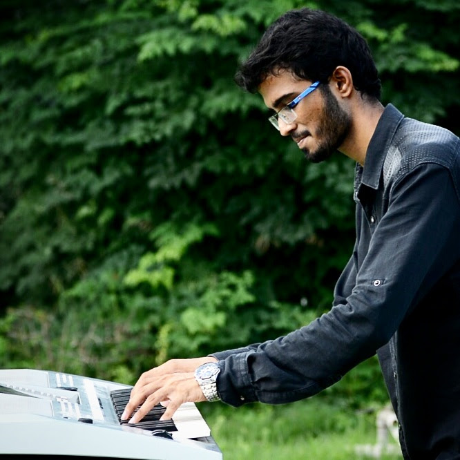Yashodeep practicing keyboard outdoors, side profile