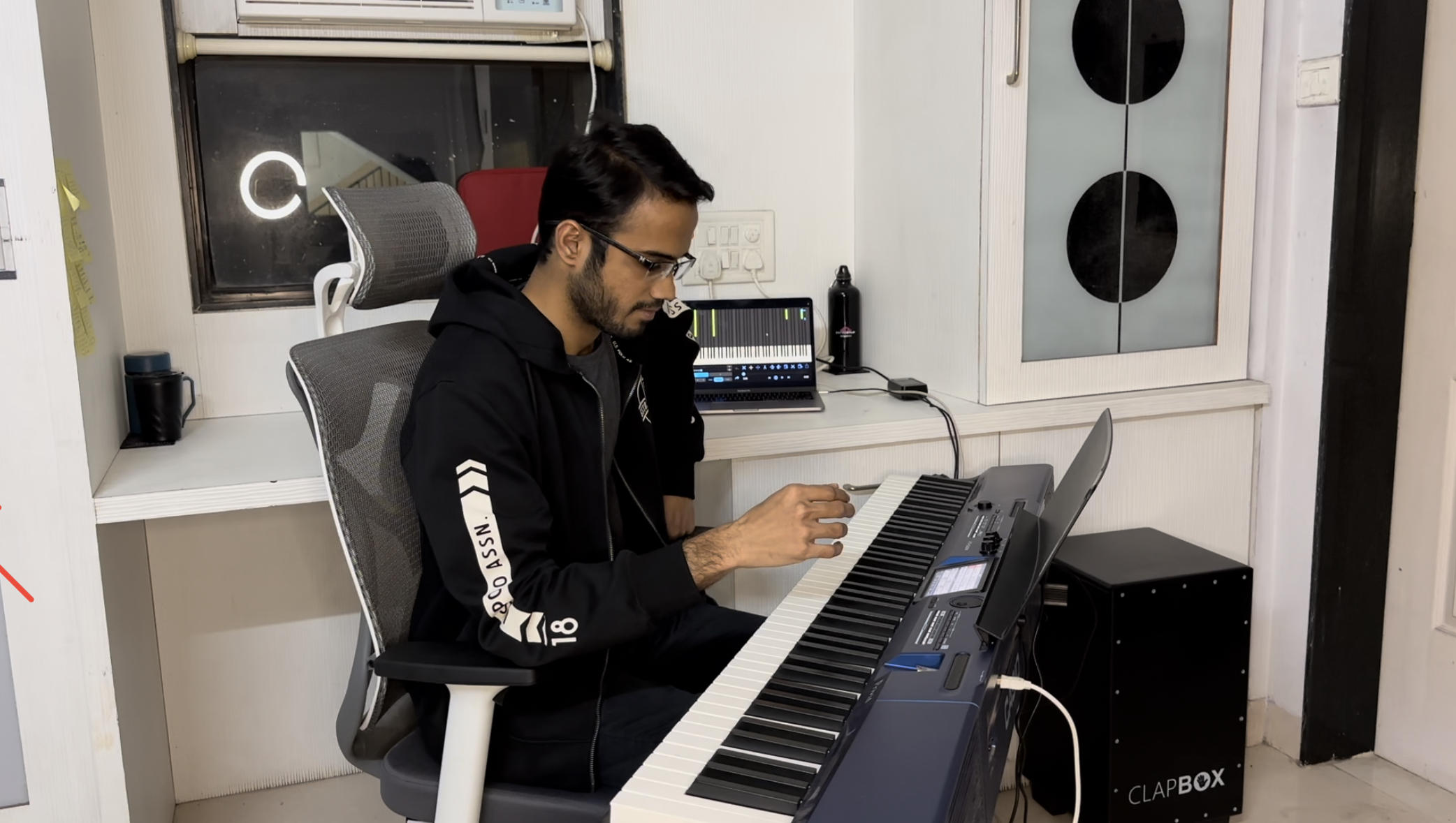 Yashodeep's home studio setup with Clapbox keyboard, laptop running piano software, and ring light
