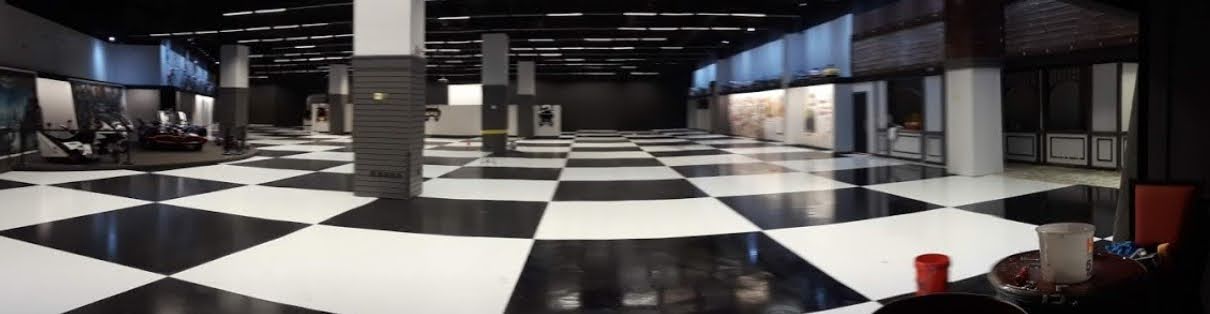 Black and white checkered commercial showroom epoxy floor — precision pattern installation, Central Florida
