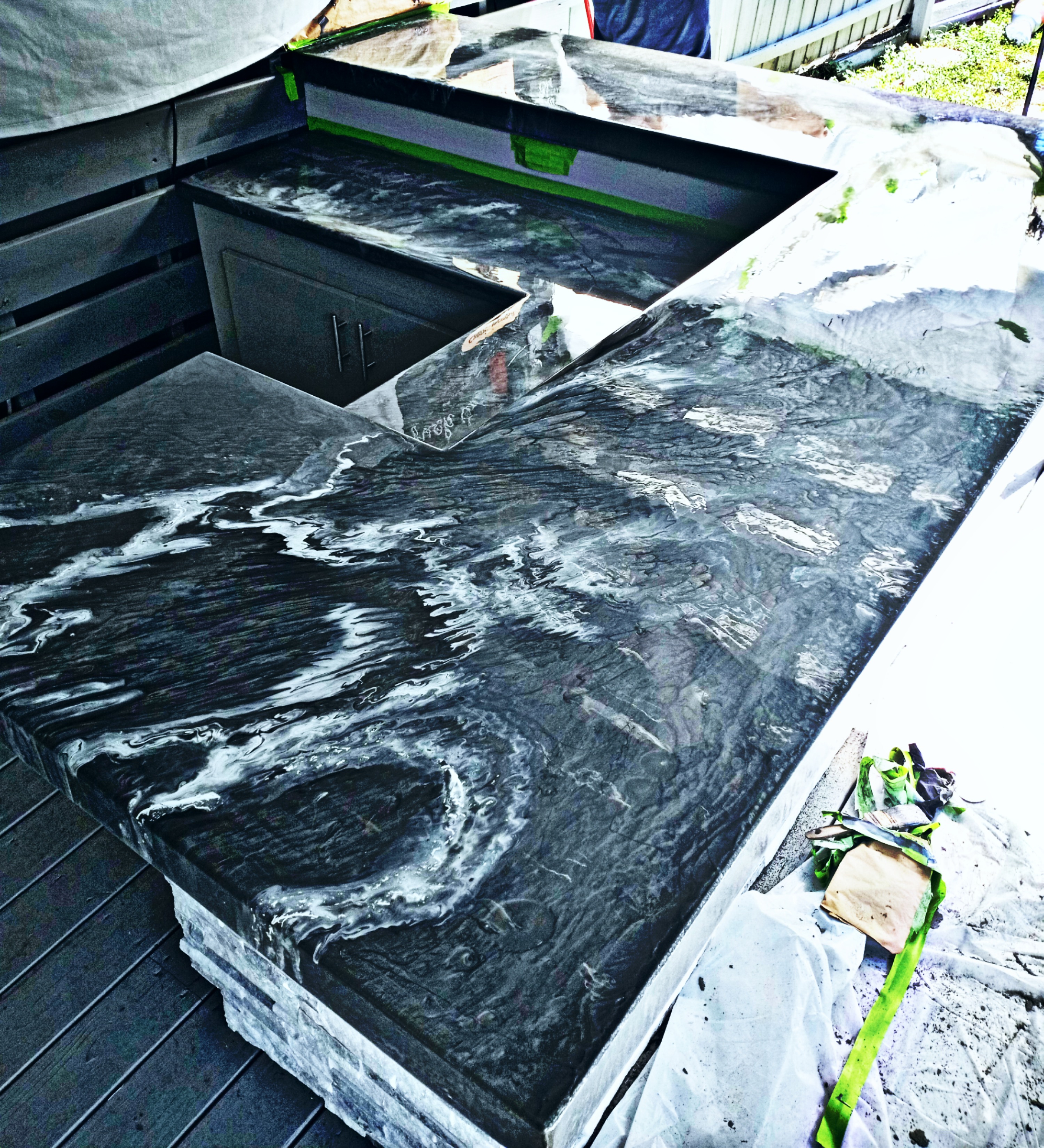 Metallic epoxy outdoor kitchen counter — black and silver marble effect by Southern Epoxy Coatings