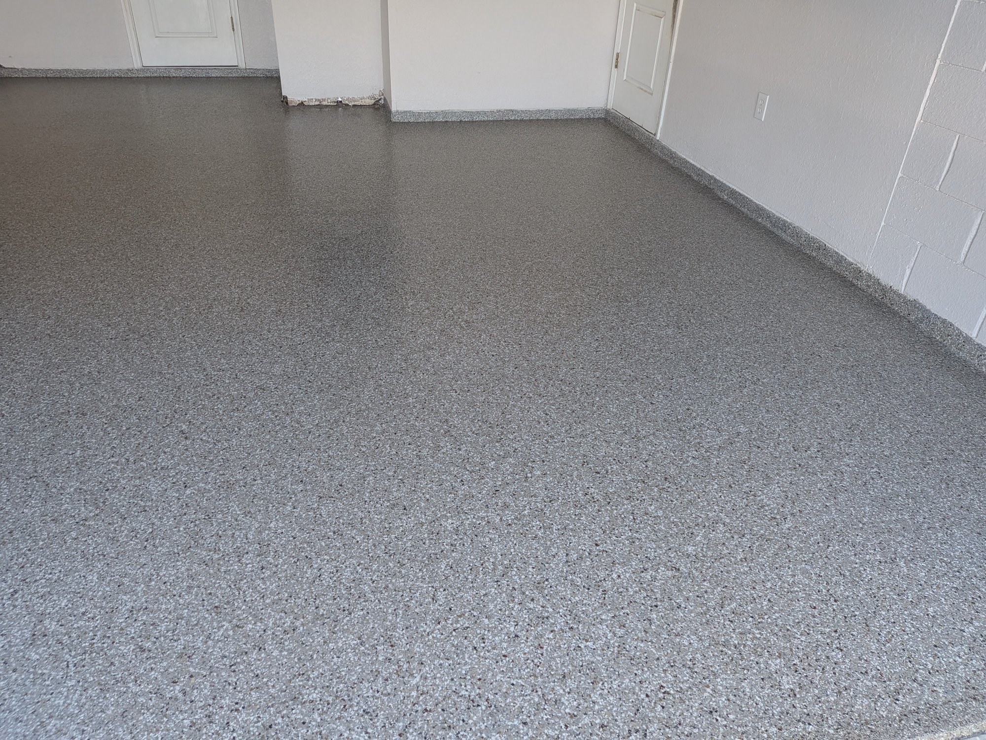 Gray flake epoxy garage floor — wide shot, clean uniform finish, 2-car garage, Central Florida