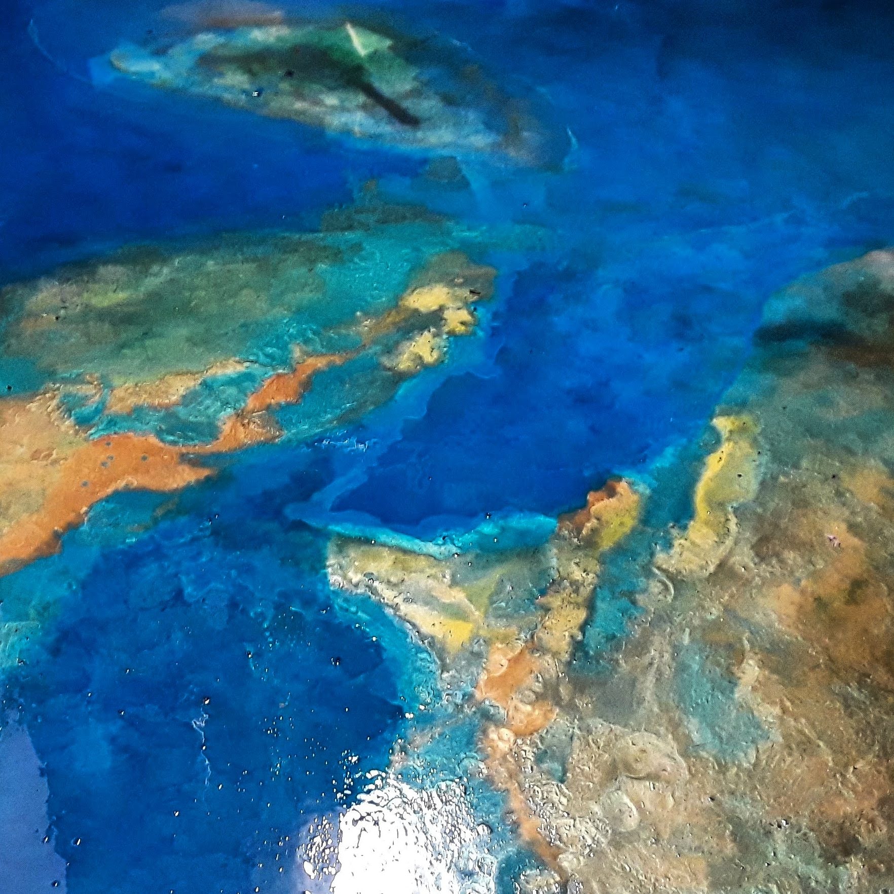 Metallic epoxy floor in Central Florida — ocean effect with turquoise and copper tones