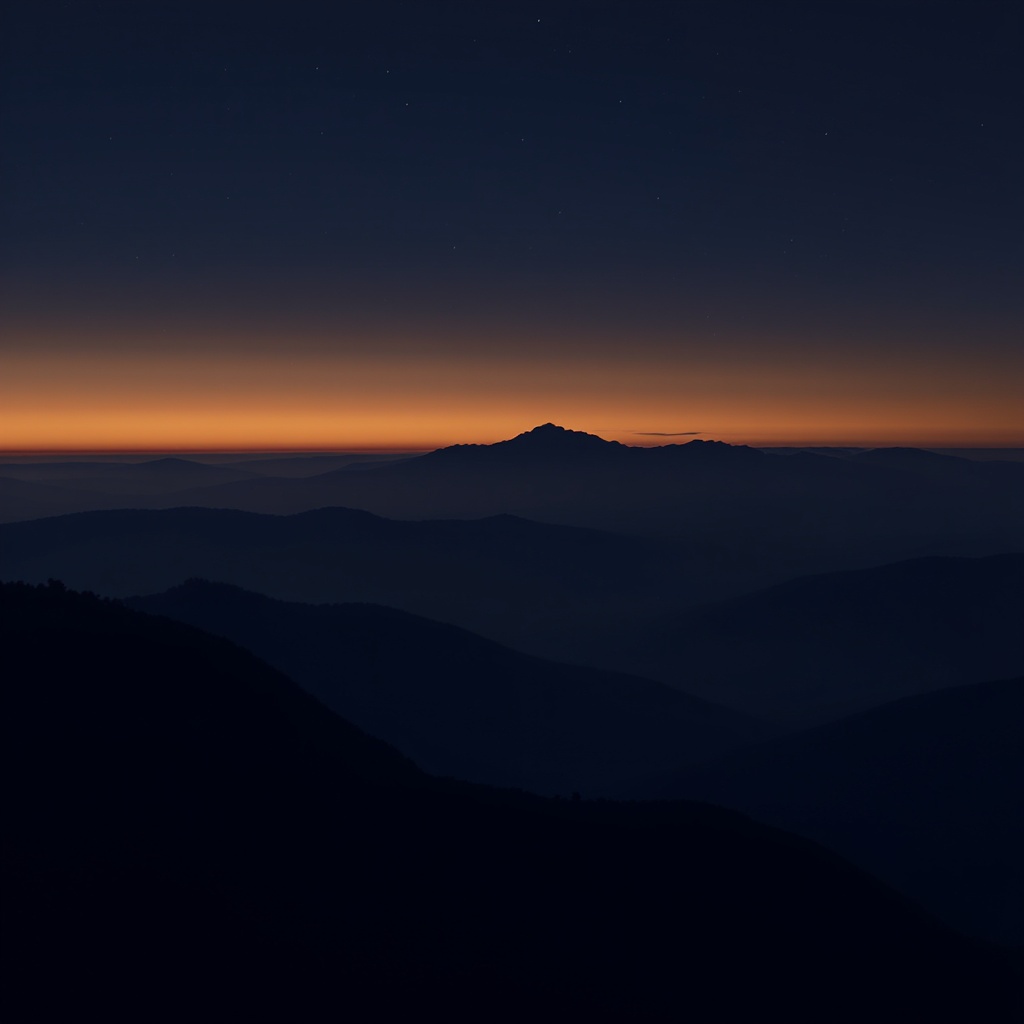 Mountain silhouette at dusk — layered ridgelines in deep indigo